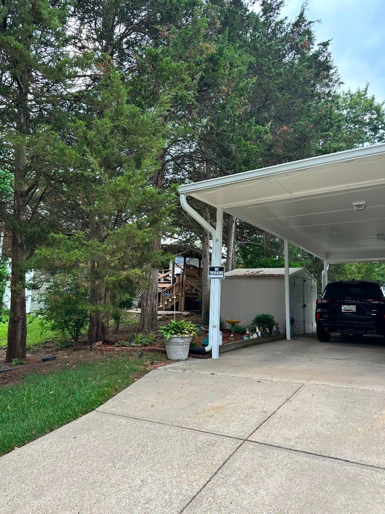 Aluminum carport installation with vehicle parked underneath
