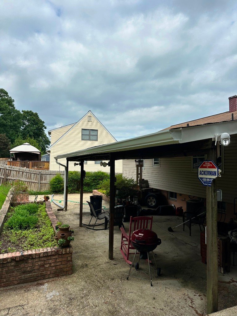 Covered patio roofing project with aluminum panels and support posts in Laurel, MD