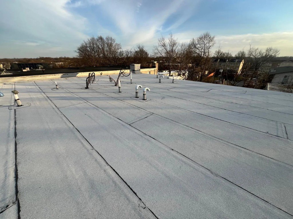 EPDM flat roof membrane on a commercial building with pipe boot flashing