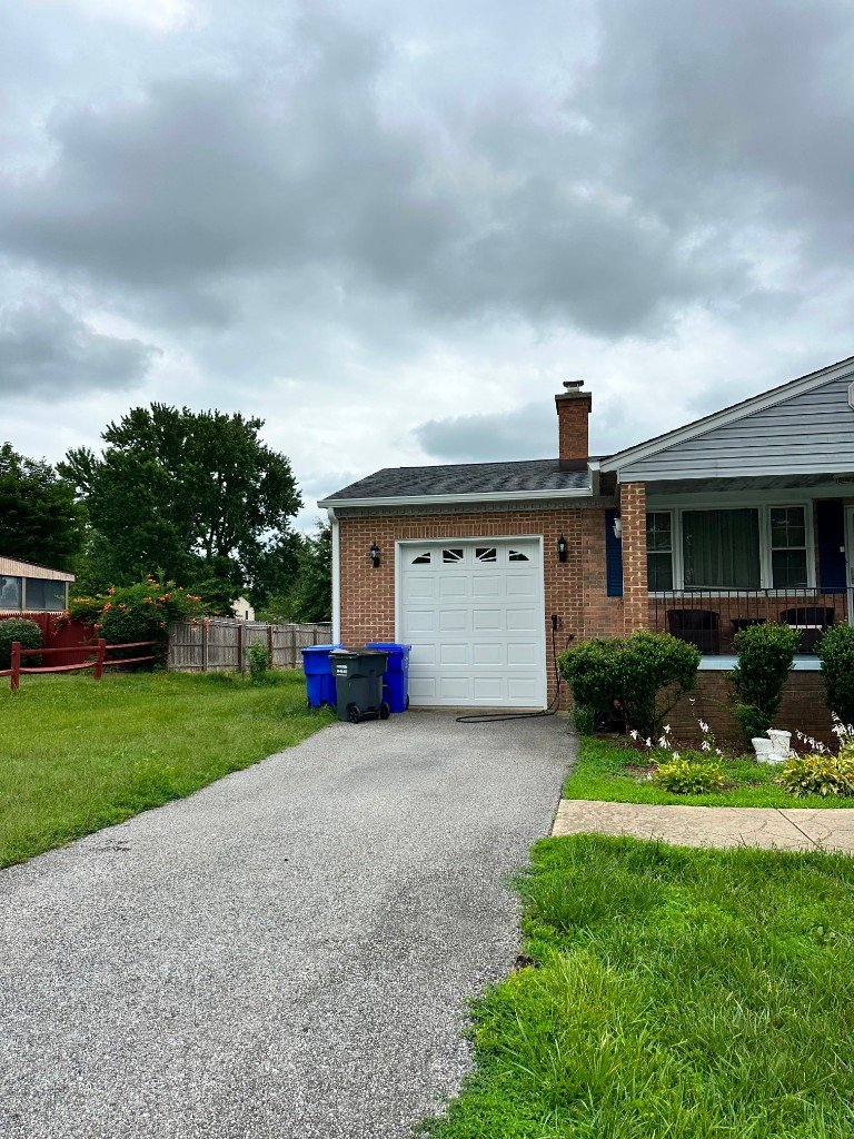 Brick home exterior with new roofline and gutter system in Laurel, MD