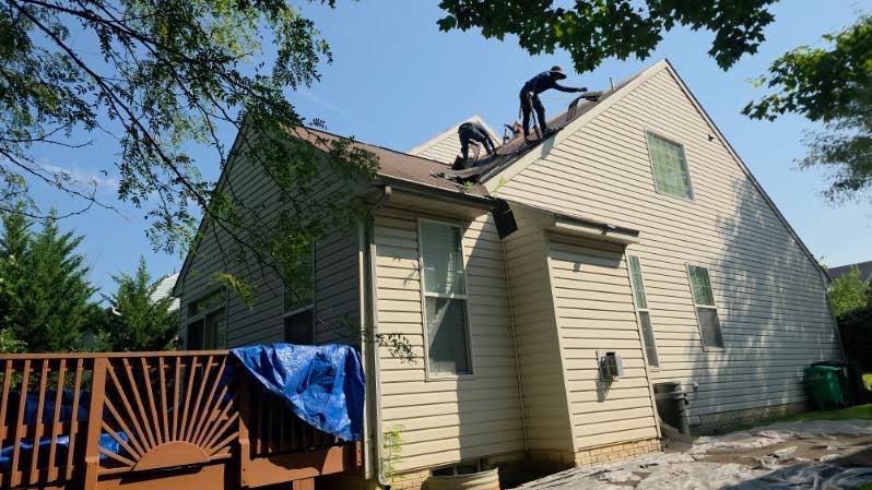 Sunrise Construction crew replacing a roof on a home in Laurel, MD