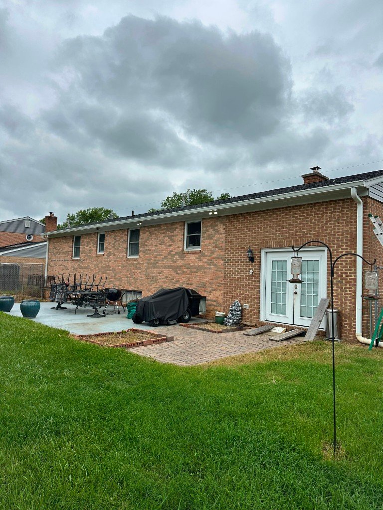 Seamless aluminum gutters installed on a brick rambler home